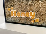 Honey static cling name sticker by Furnishables stuck to the front of a glass pet enclosure