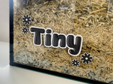 Black static cling name sticker by Furnishables stuck to the front of a glass pet enclosure