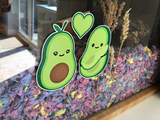 Furnishables avocado themed static cling stickers stuck to the front of a glass pet habitat with colourful bedding
