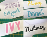 Examples of custom printed pet name stickers in their envelopes. Made by Furnishables